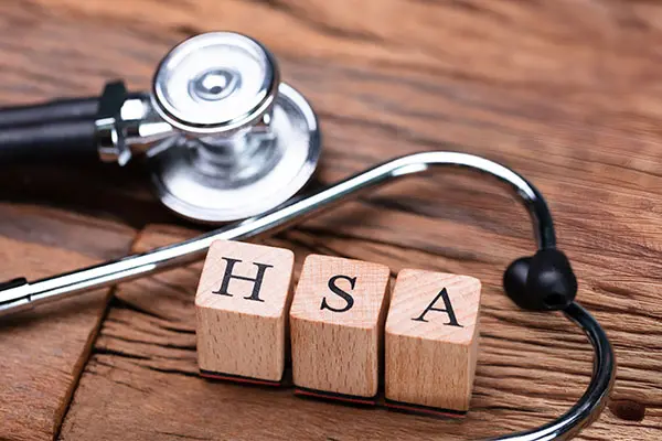 A stethoscope and wooden blocks that spell HSA