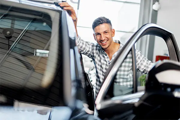 Over the shoulder view of a man driving a car